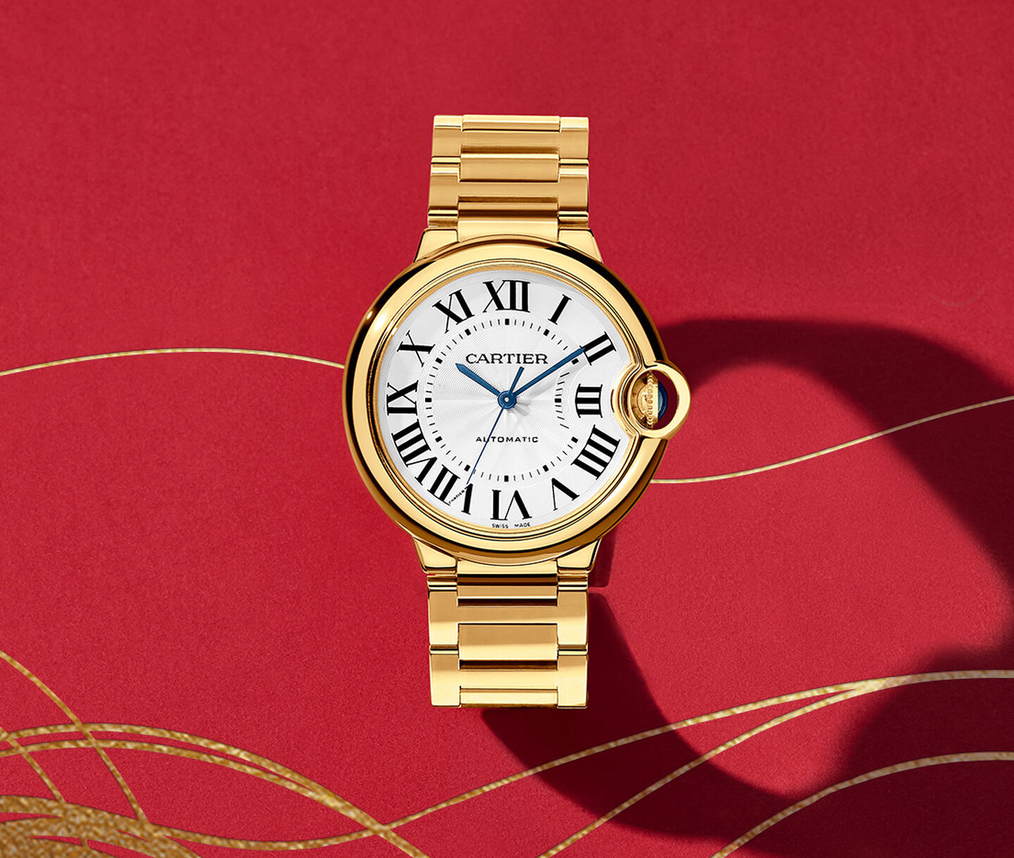 Ballon Bleu de Cartier watch on a red background.