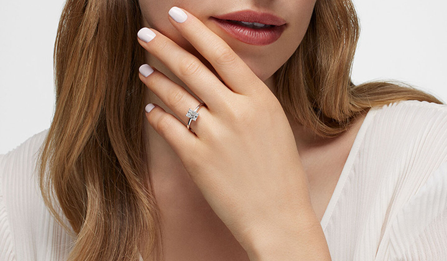 A woman wearing a Birks Essentials diamond ring.