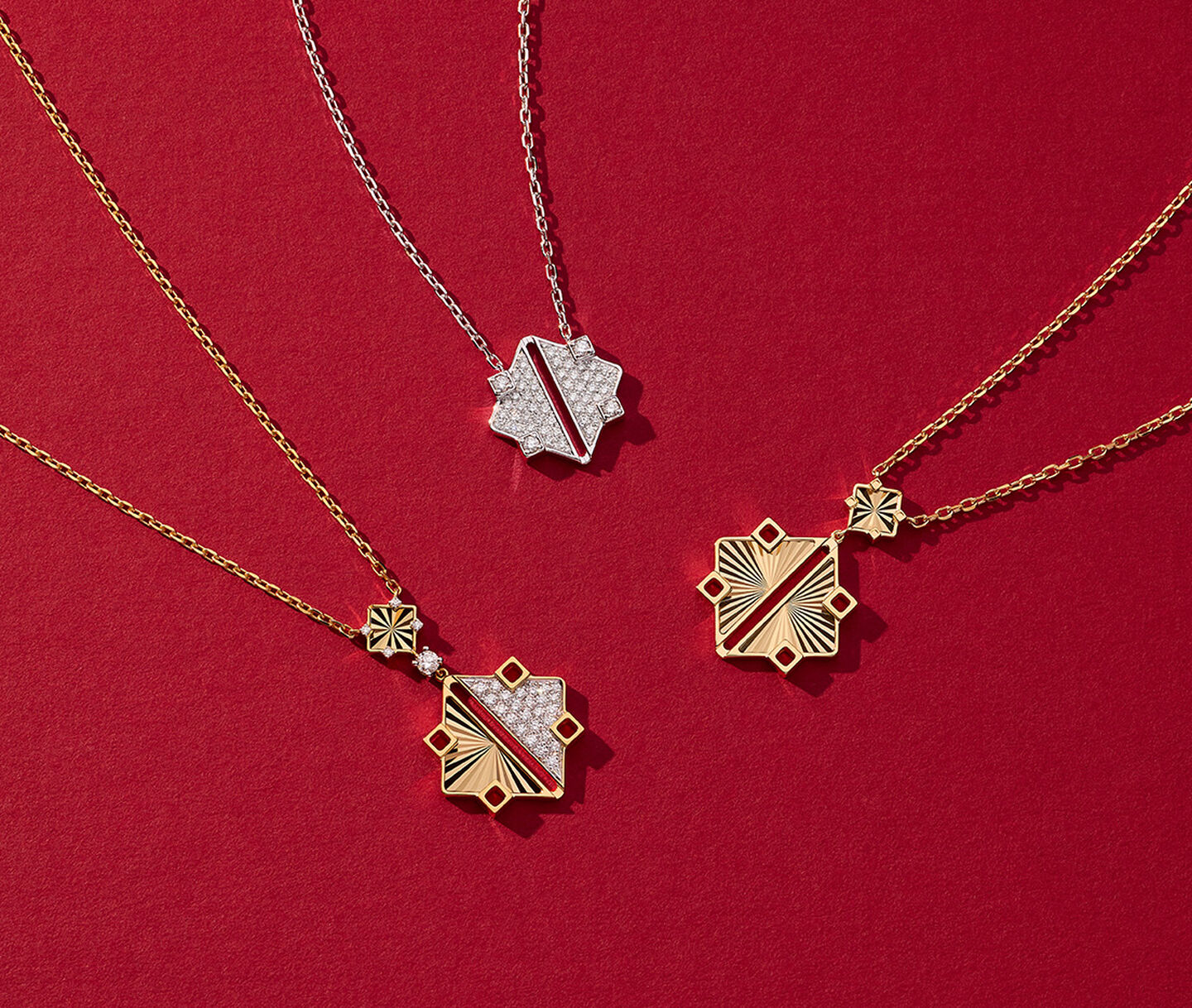 Three Birks Muse gold and diamond pendants on a red background.