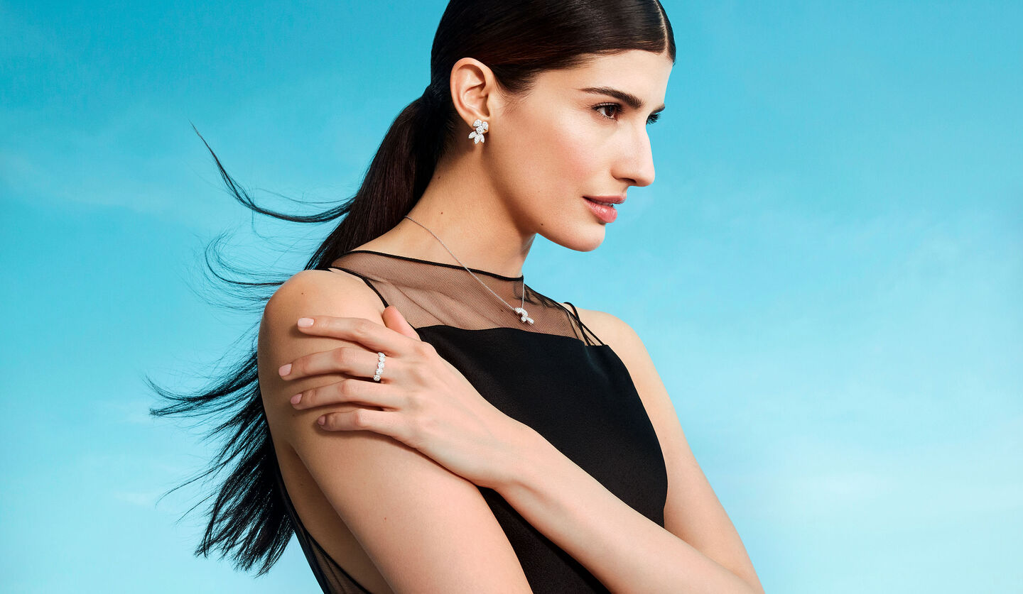 A woman wearing Birks Snowflake diamond jewellery.