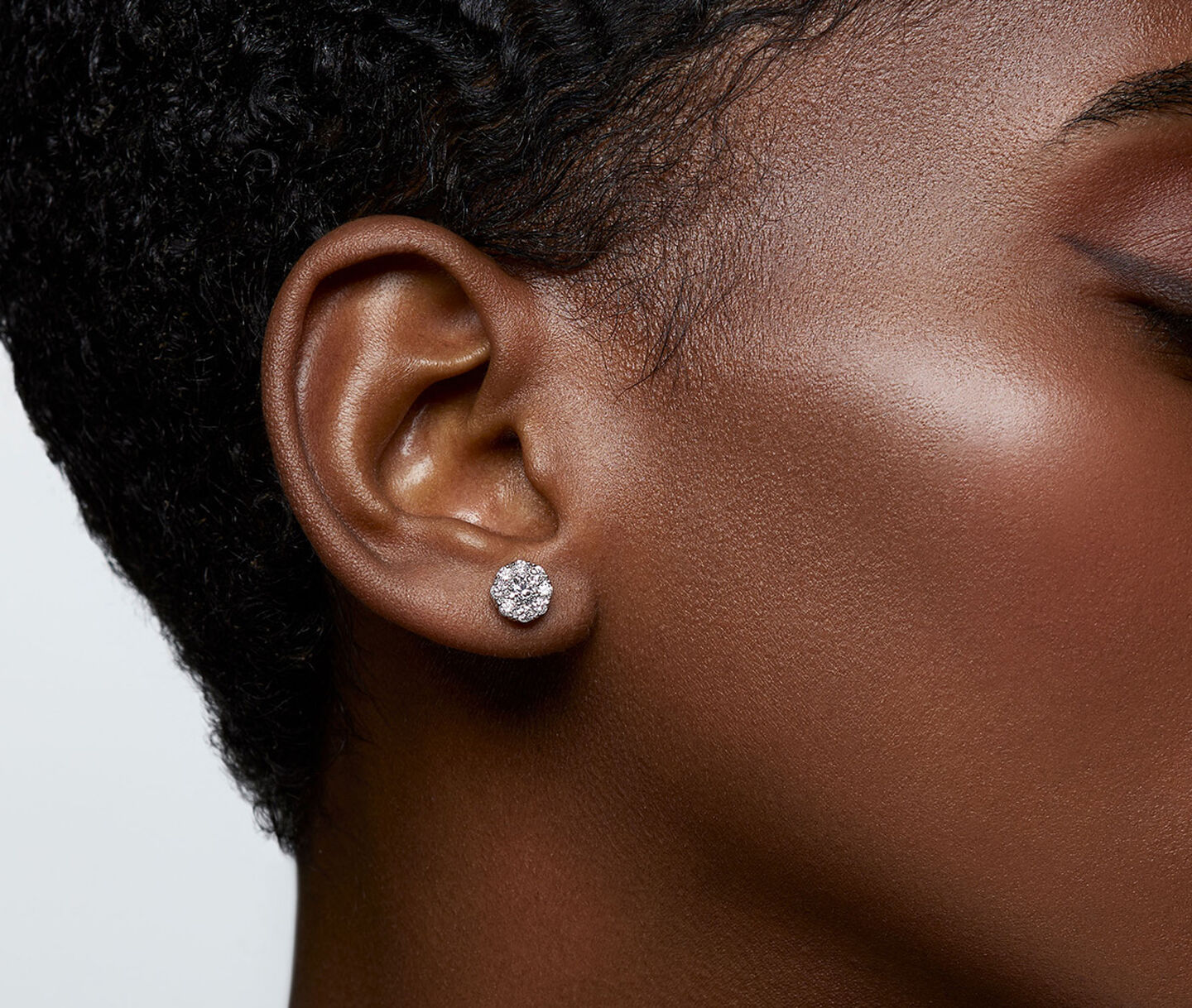A woman wearing Birks Snowflake diamond stud earrings.