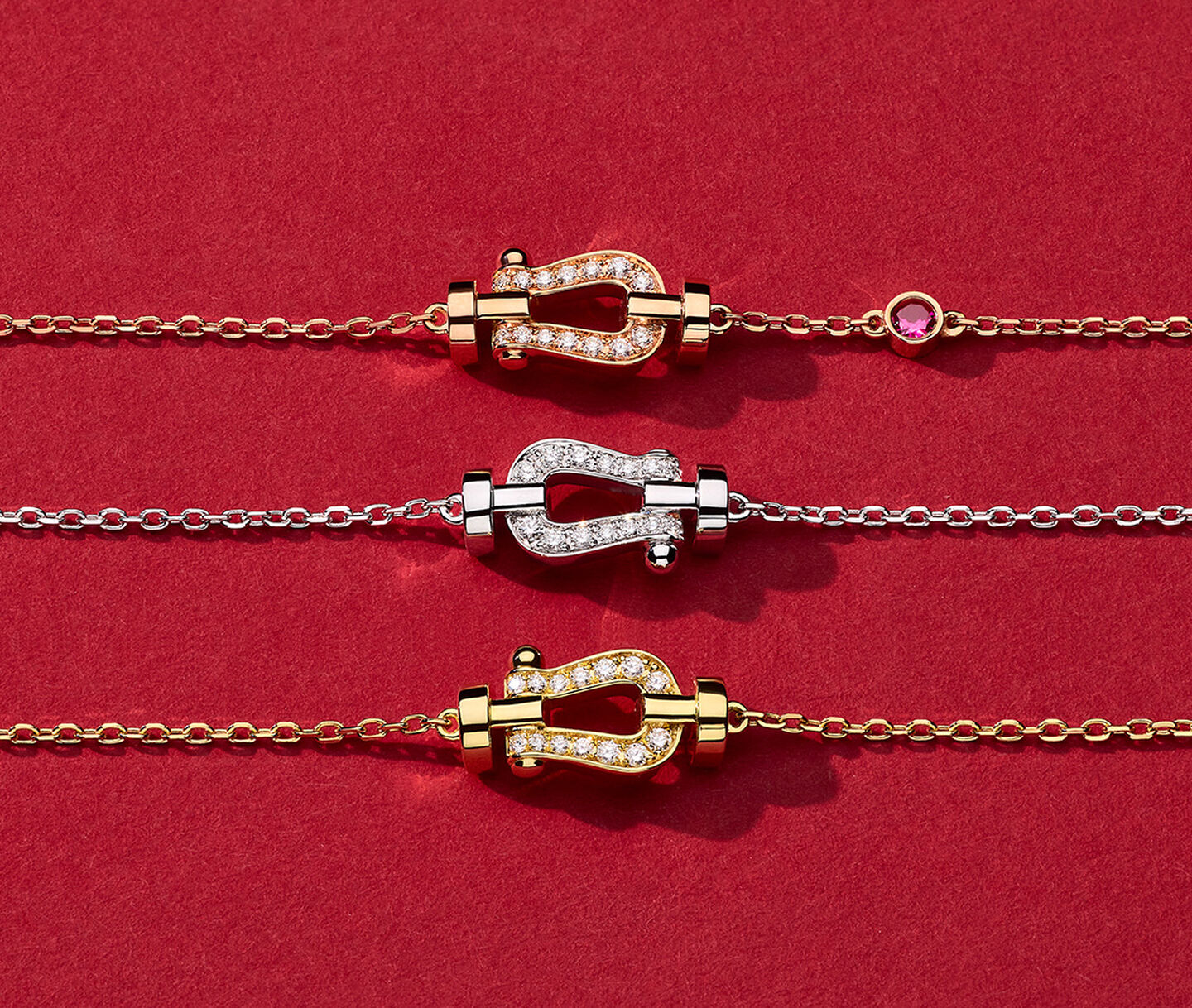 Three red FRED Force 10 necklaces on a red background.
