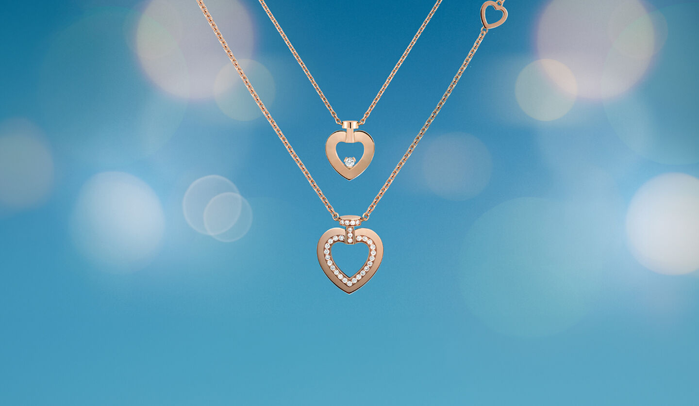 Two Pretty Woman rose gold necklaces from FRED on a blue background.