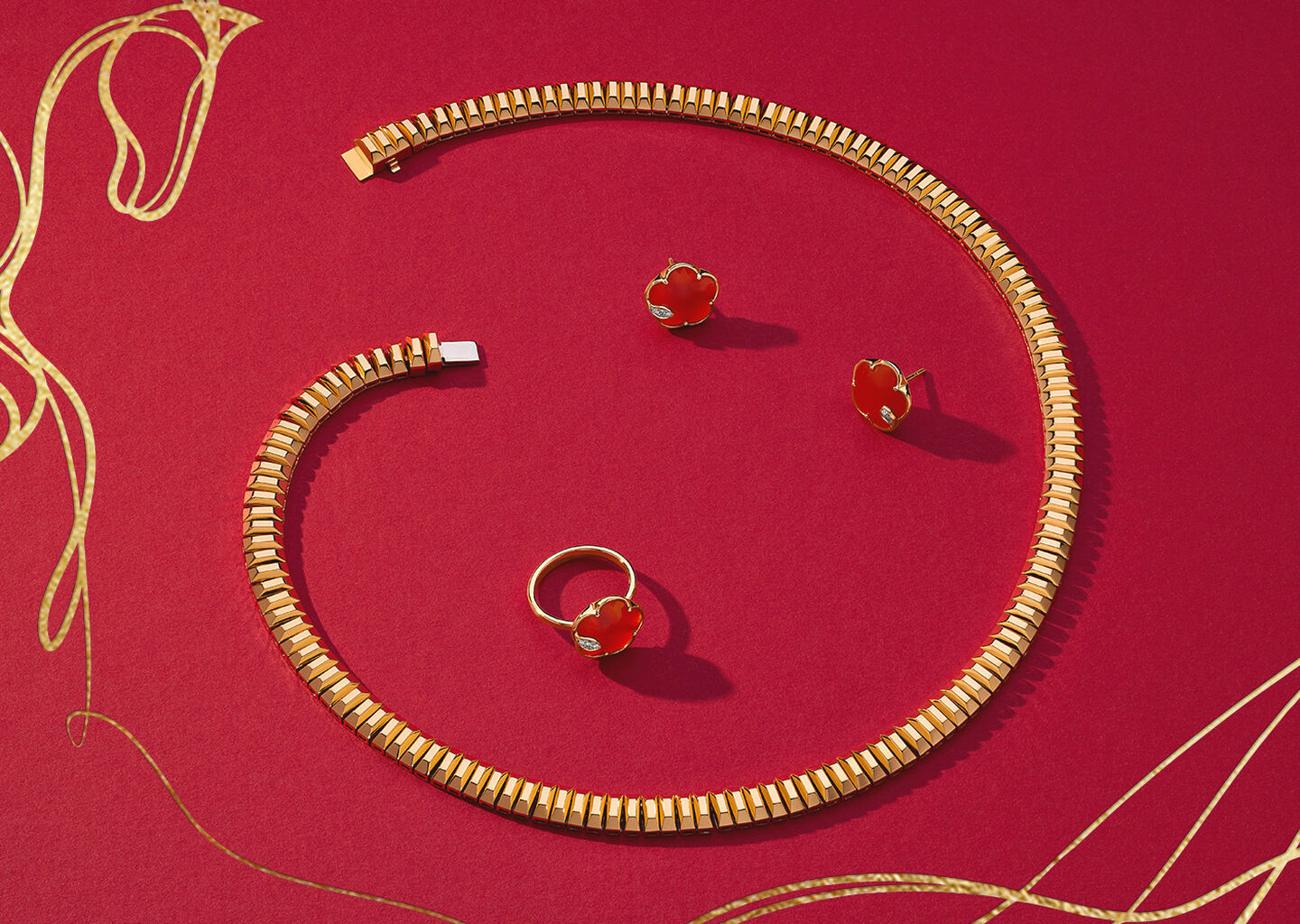 Yellow gold jewellery from Maison Birks on a red background with a horse illustration,