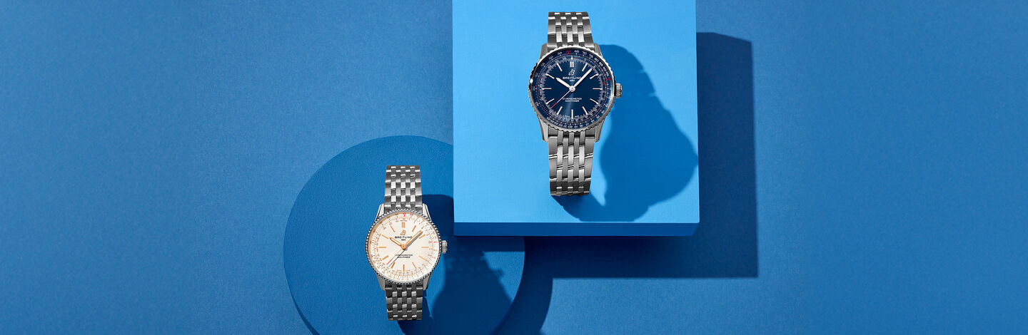 Breitling navitimer watches on a blue background.