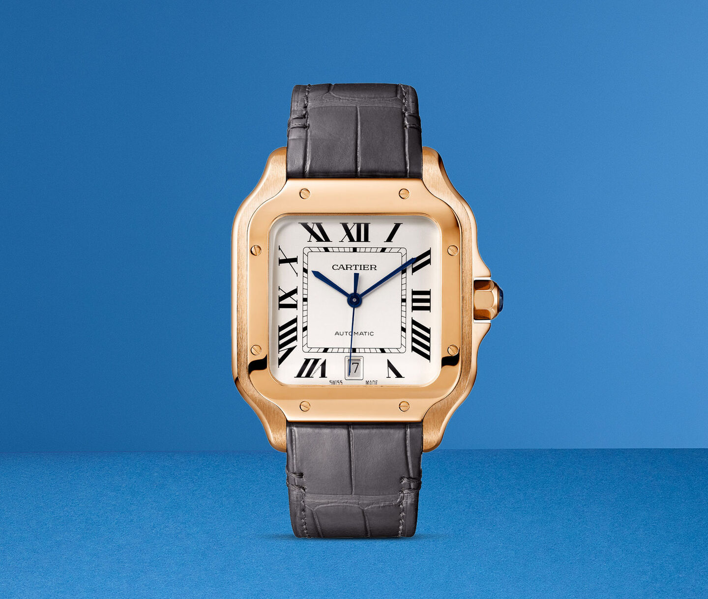 A Cartier Santos in solid gold on a blue background.