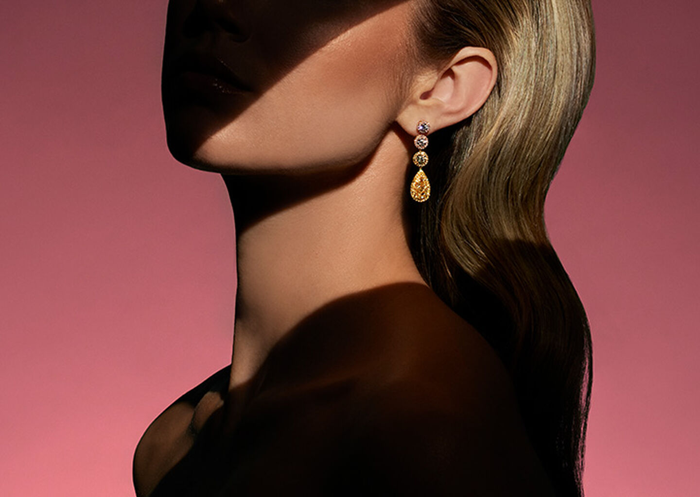 A model wearing diamond earrings from the Maison Birks high jewellery collection on a red background