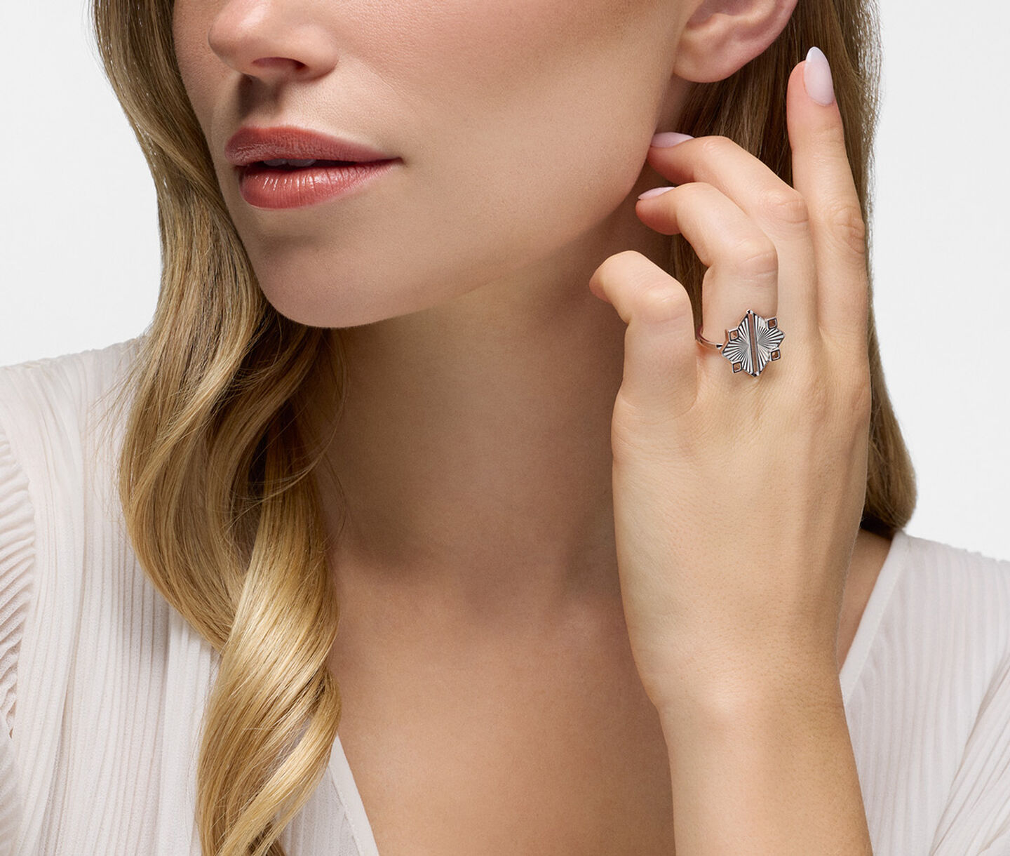 A woman wearing a Birks Muse silver ring.