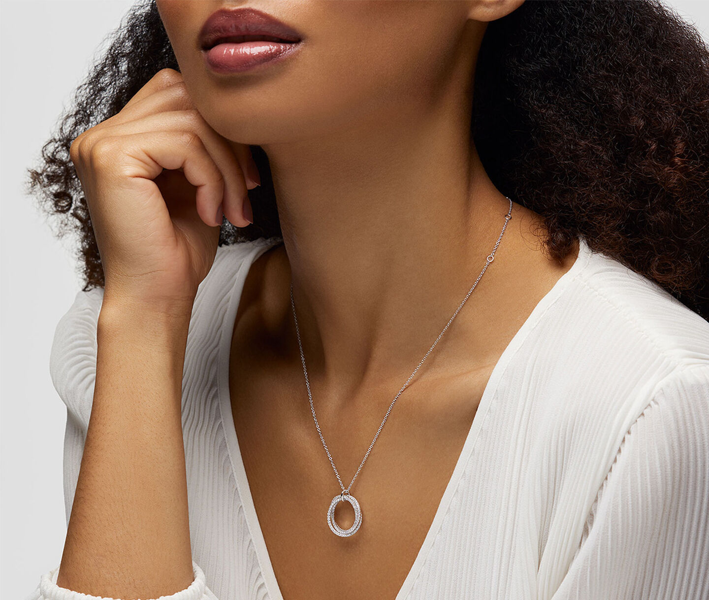 A woman wearing a Birks Rosee du Matin necklace.