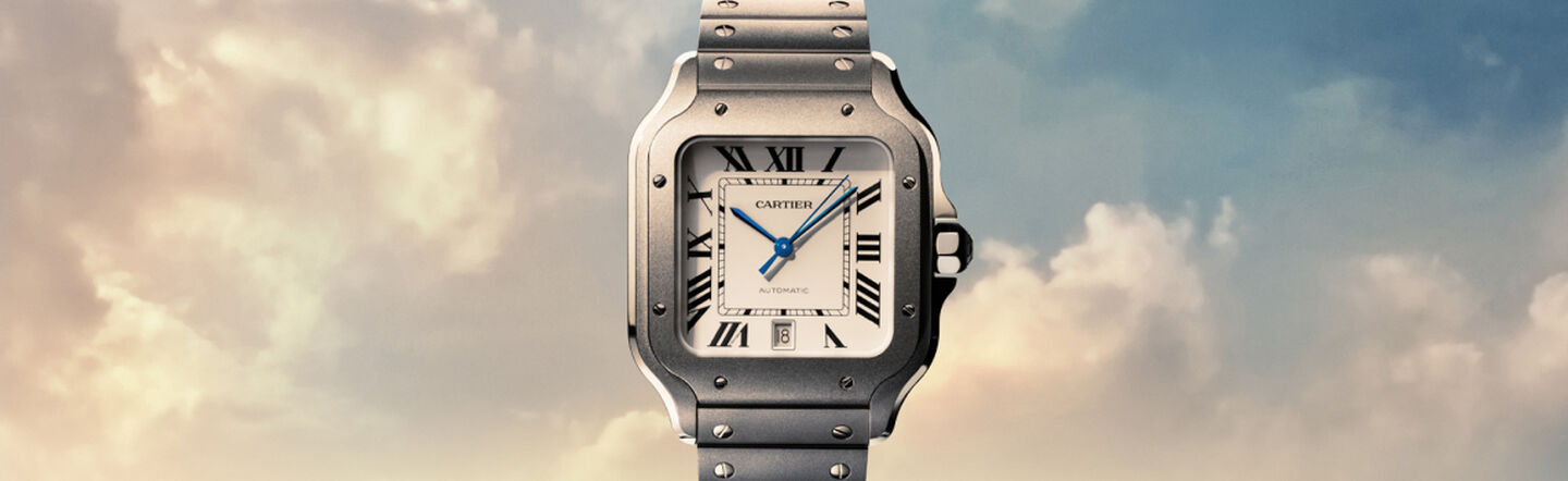 Santos de Cartier titanium watch on a sky background.