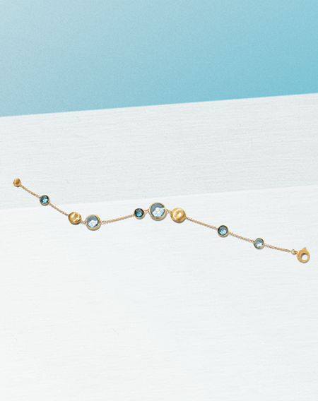 Marco Bicego topaz bracelet on a white and light blue background