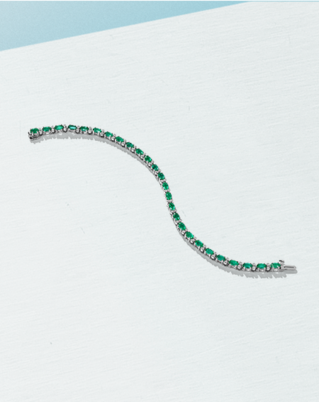 Salon emerald and diamond bracelet on a white and light blue background