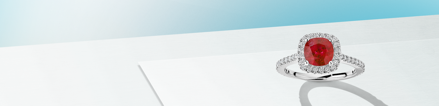 Birks Salon ruby and diamond ring on a blue background.