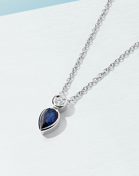 Birks Bunny silver necklace on a light blue background