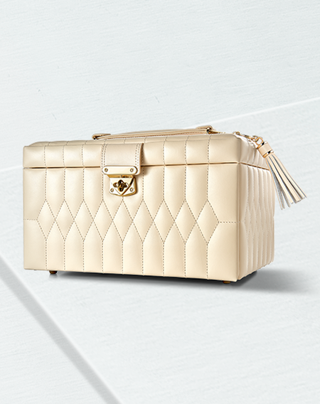 Wolf Caroline in ivory colour jewellery box on a light blue background.