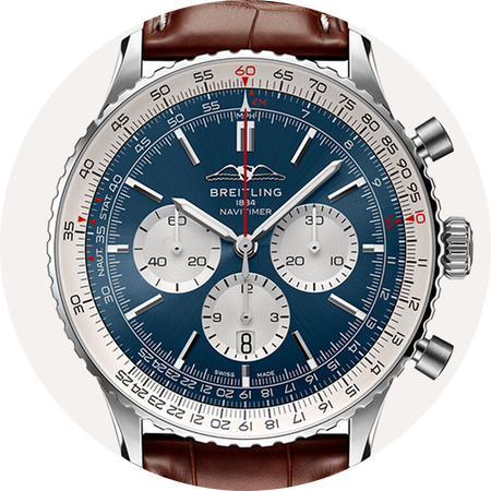 Breitling Navitimer watch on a beige background.