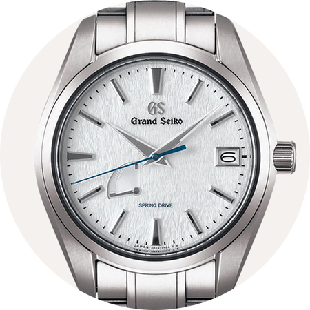 Grand Seiko watch on a grey background.