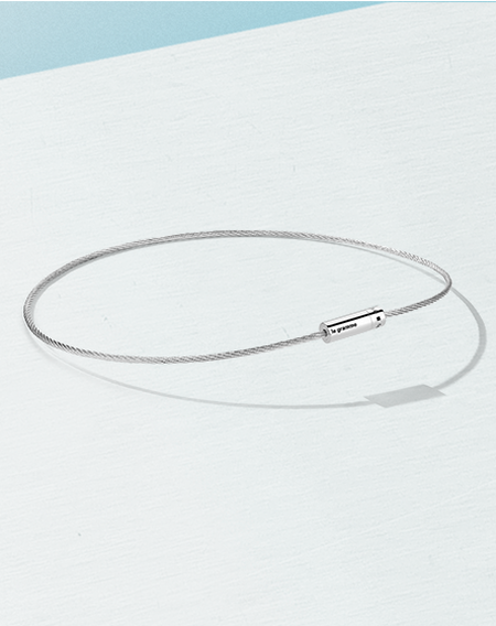 le gramme cable bracelet on a light and baby blue background