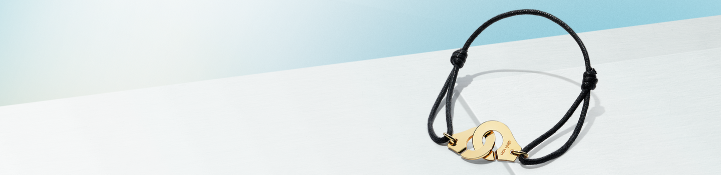 dinh van Menottes yellow gold bracelet on a white background.