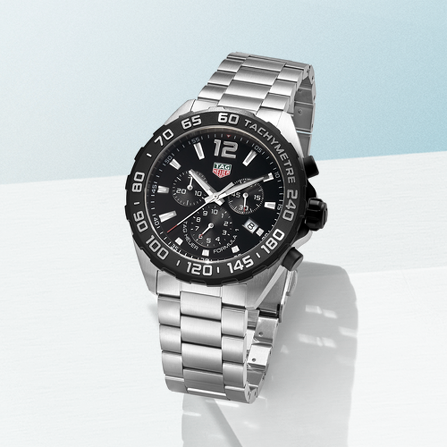 TAG Heuer Aquaracer watch on a blueish white background.