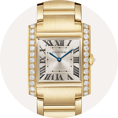 Tank de Cartier gold watch on a beige background.