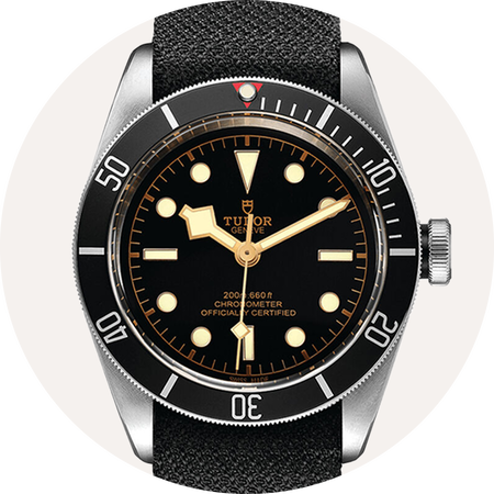 TUDOR Black Bay watch on a beige background.